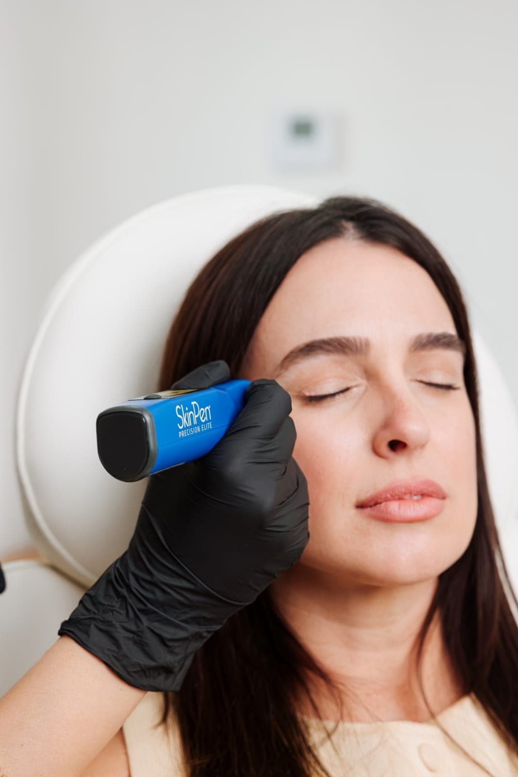 Aesthetic provider performing a microneedling treatment on a client at a Miami medical spa